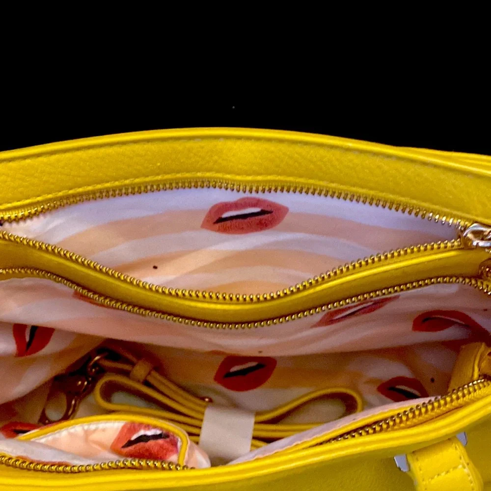 YELLOW EVA MENDES NEW YORK & COMPANY HANDBAG. It has 2 dividers with zippers.